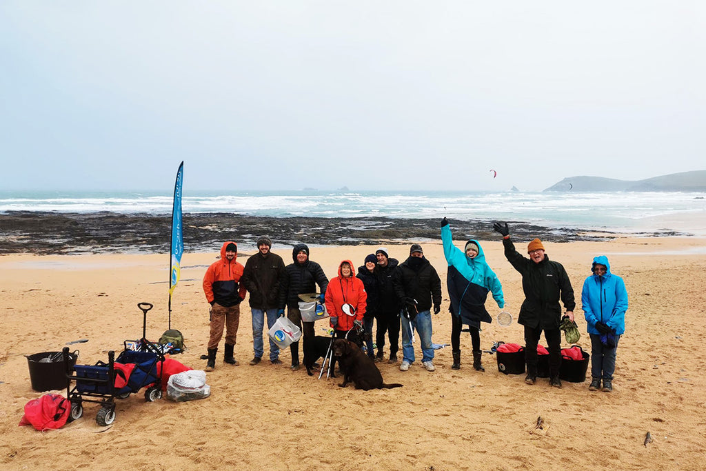 beach guardian team stand on the beach before a litter pick